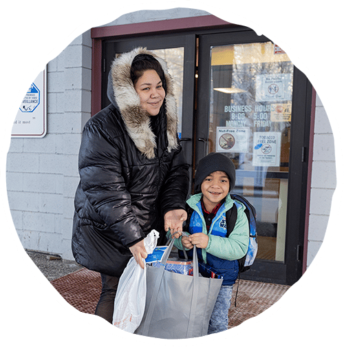 Woman and young boy holding groceries