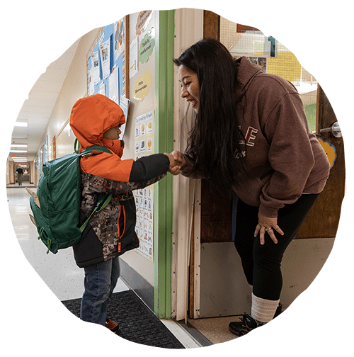 Woman shaking young boys hand